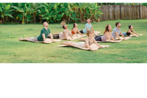 Participants practicing heart-opening asana during a 7 chakras retreat