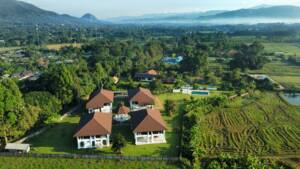 Bird’s-eye view of Amrita Integral Yoga Centre with four buildings, central altar, and pool